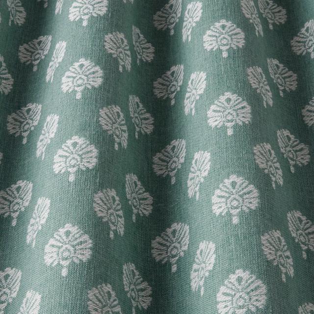 Sea-green woven fabric with small pale leaf motifs and a subtle textured surface