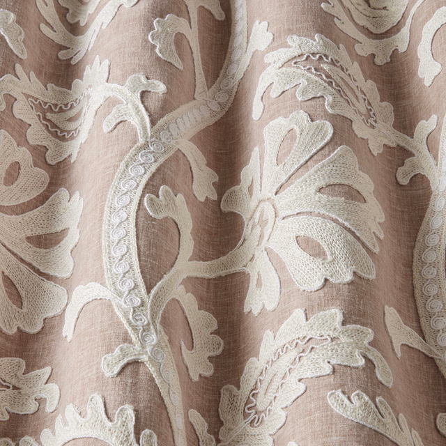 Blush pink textured fabric with large cream embroidered leaf motif