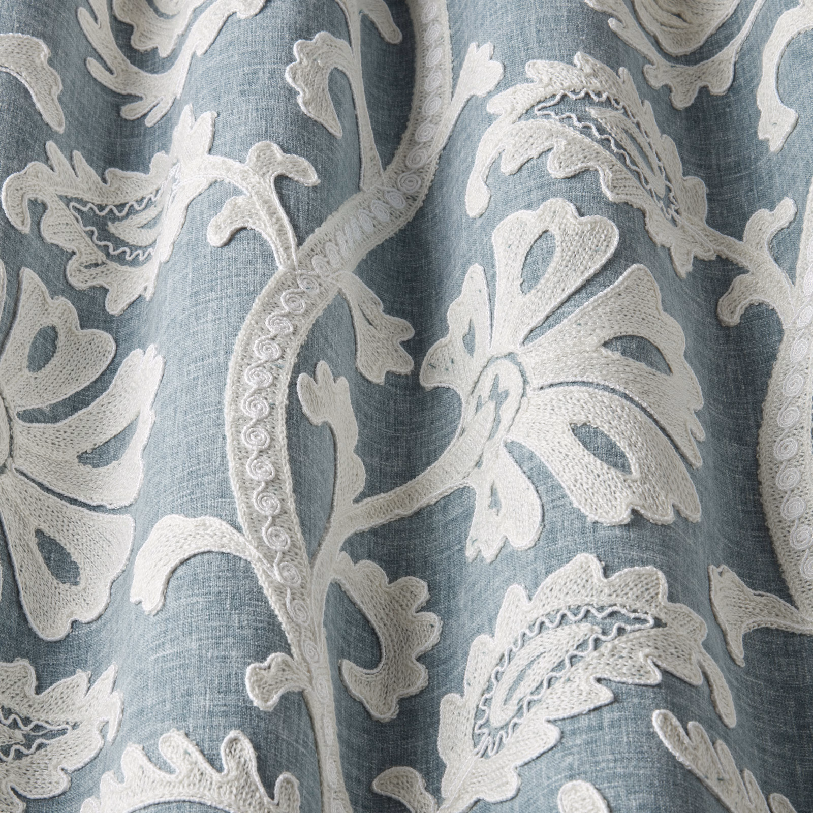 Glacier blue embroidered fabric with raised ivory botanical leaves