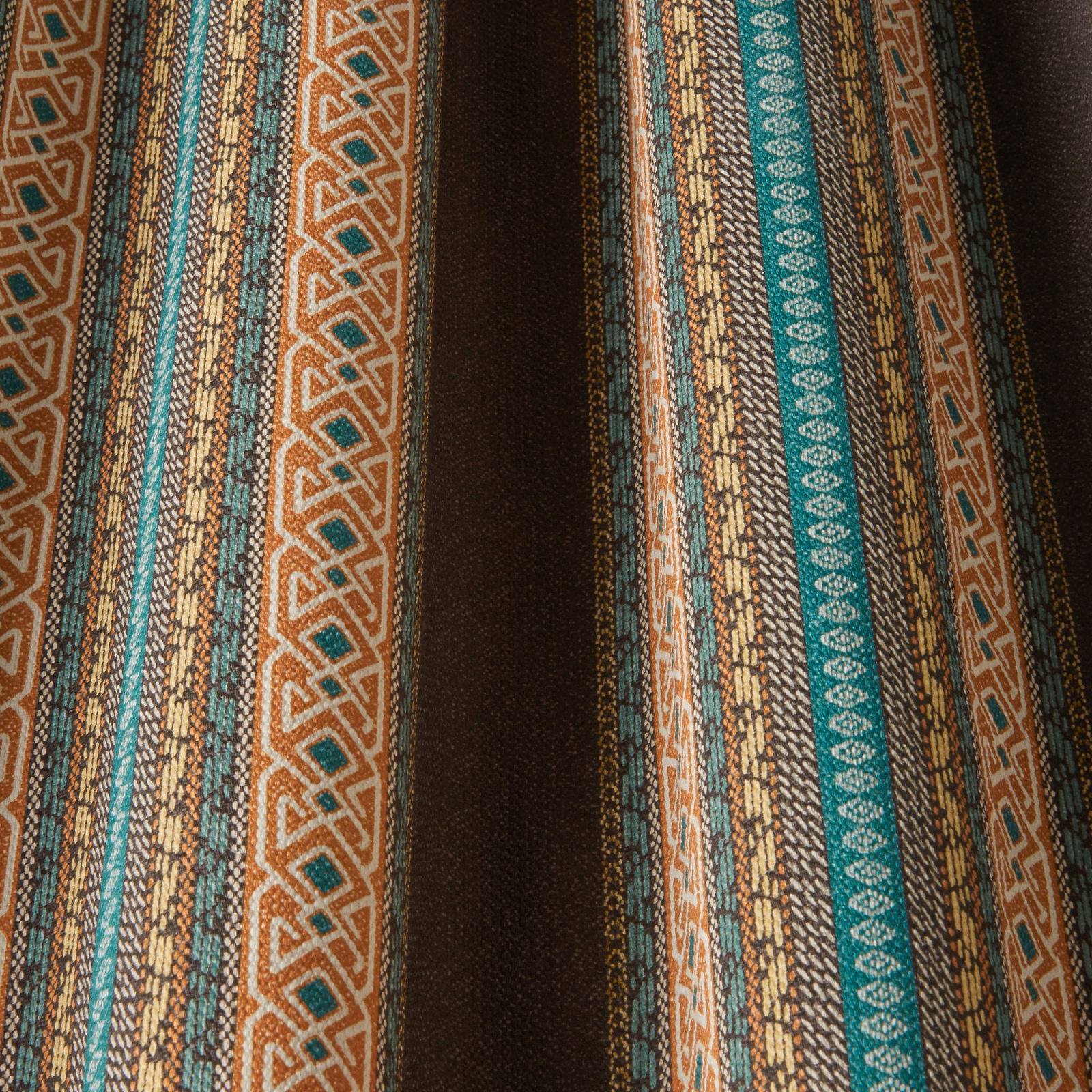 Charcoal brown woven stripe fabric with teal, rust and gold geometric bands