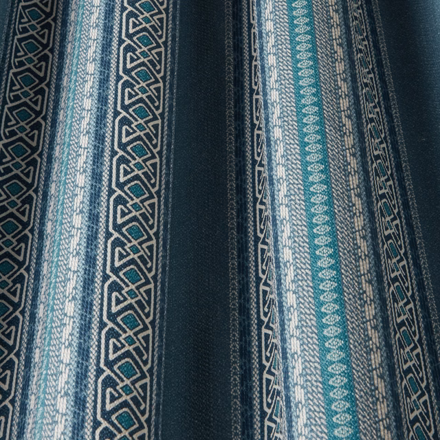 Vertical denim-blue and teal striped fabric with ivory geometric pattern bands