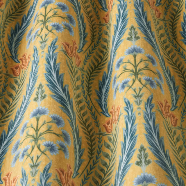 Ochre velvet fabric with large blue and green botanical waves