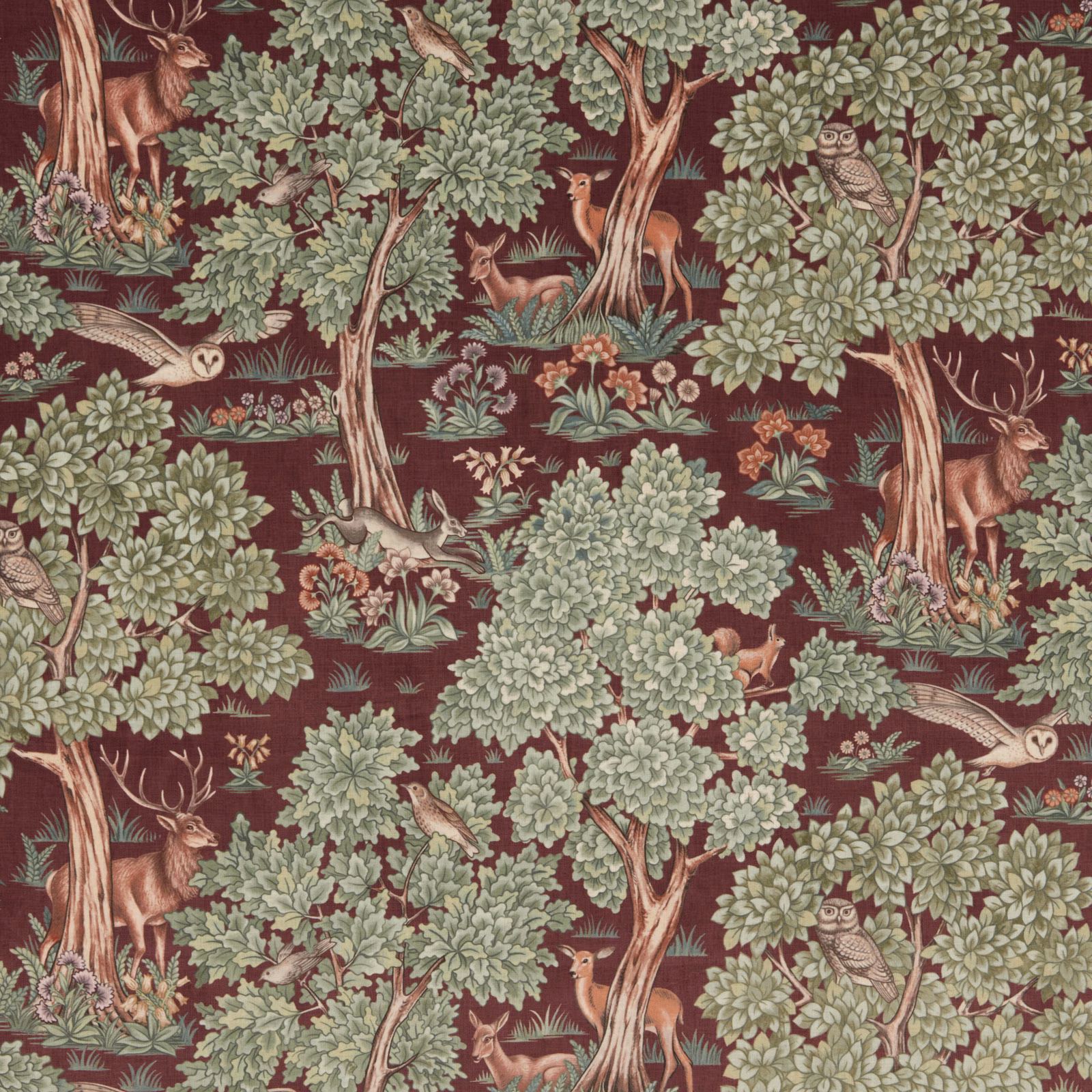 Woodland animal print fabric with burgundy ground, pale green trees and deer