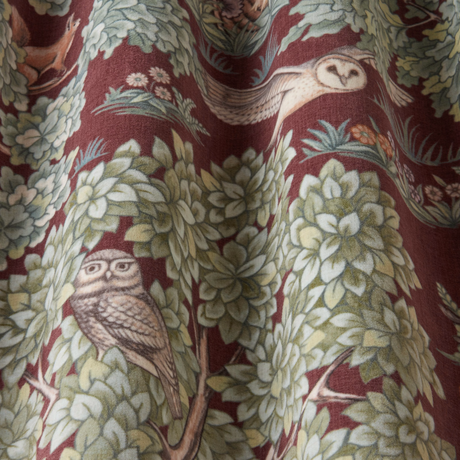 Bordeaux woven fabric with owls and leafy botanical repeat