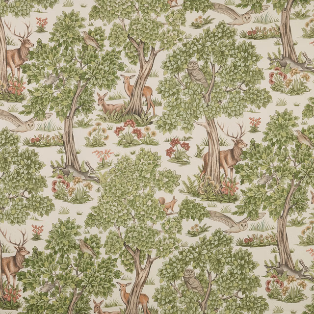Sage woodland print with deer, owls and leafy trees on a pale ground