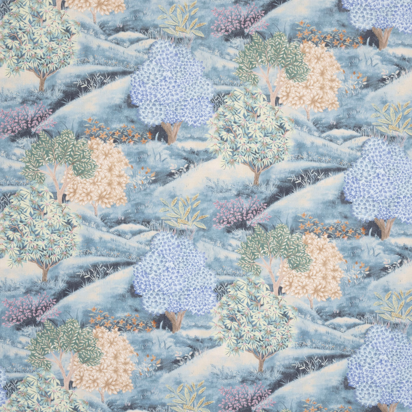 Embroidered botanical fabric in soft indigo, blue hills and pastel trees