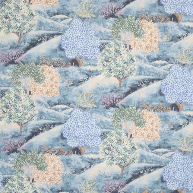 Embroidered botanical fabric in soft indigo, blue hills and pastel trees