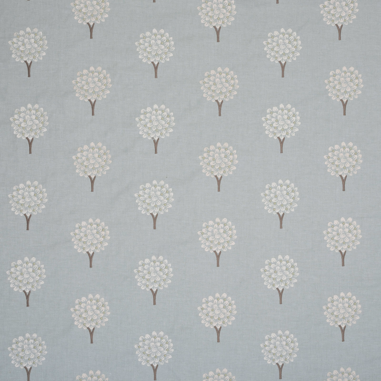 Pale aqua embroidered fabric with small tree motifs and brown stems