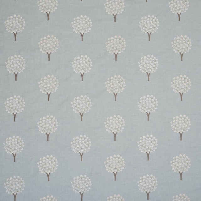 Pale aqua embroidered fabric with small tree motifs and brown stems