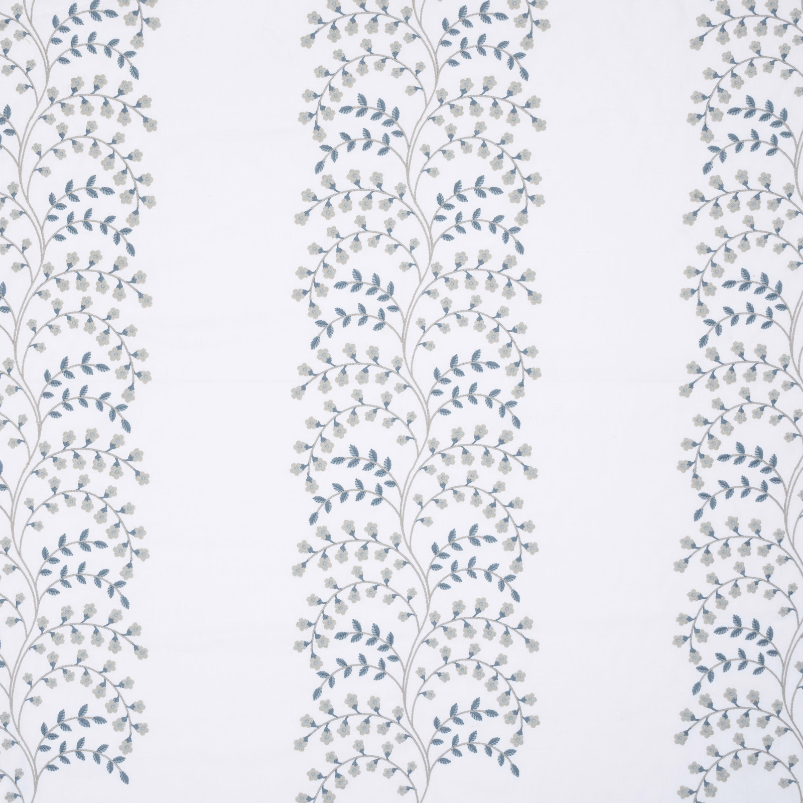 Pale ground fabric with vertical botanical vine stripes in bluestone blue and grey embroidery
