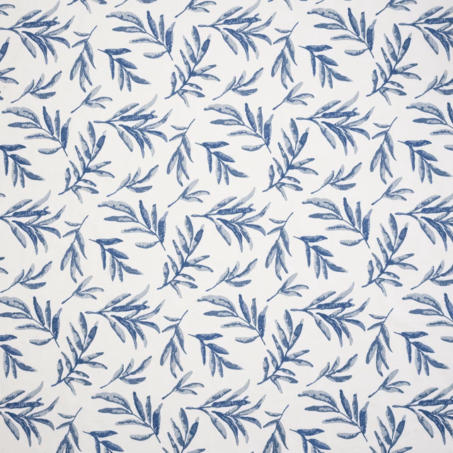 Blue botanical leaf sprigs scattered across a pale cream fabric ground