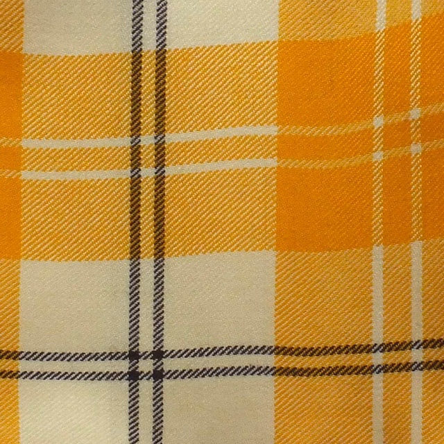 Warm ochre-gold plaid with cream blocks and dark twin stripes in a woven twill