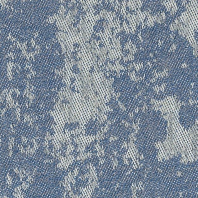 Close view of blue-grey woven texture with pale irregular flecks and layered depth