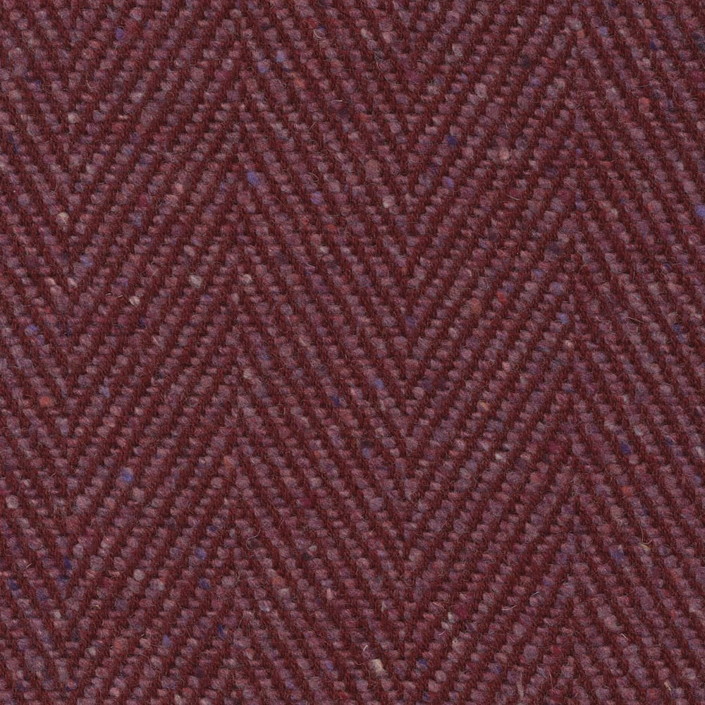 Deep damson-purple upholstery weave with a close, tactile chevron pattern