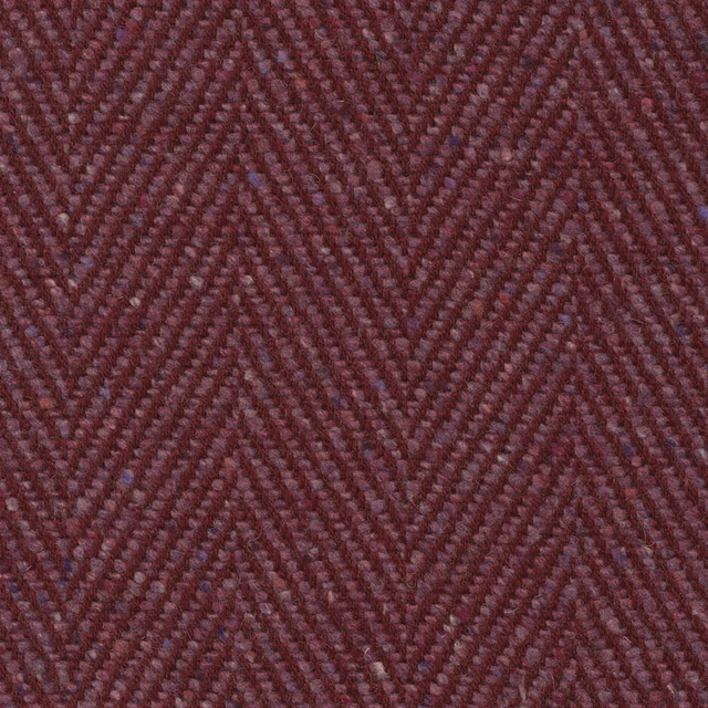 Deep damson-purple upholstery weave with a close, tactile chevron pattern