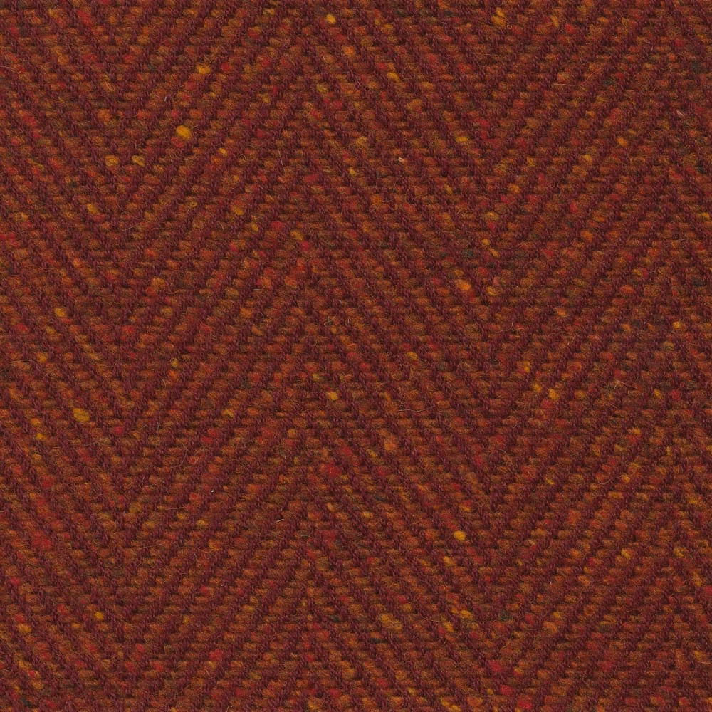 Dark amber-brown woven upholstery with rust, burgundy and fine golden chevron flecks