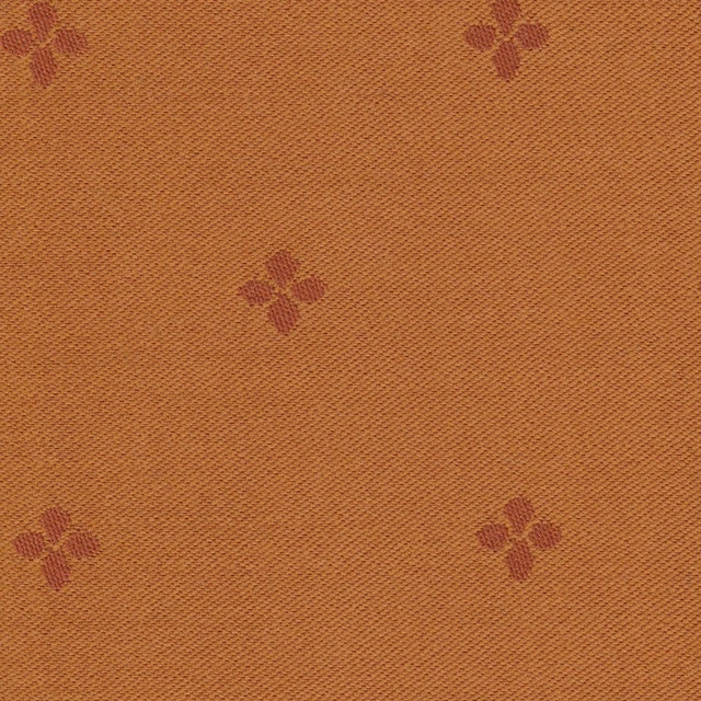 Warm ochre woven fabric with scattered muted burgundy four-petal motifs