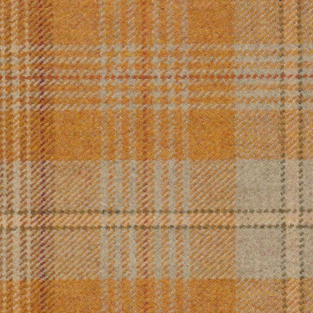 Warm ochre and rust plaid with cream and grey checks in a textured woven surface