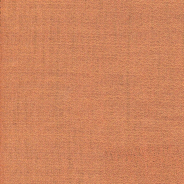 Close-up of muted terracotta fabric with a fine, even crossweave