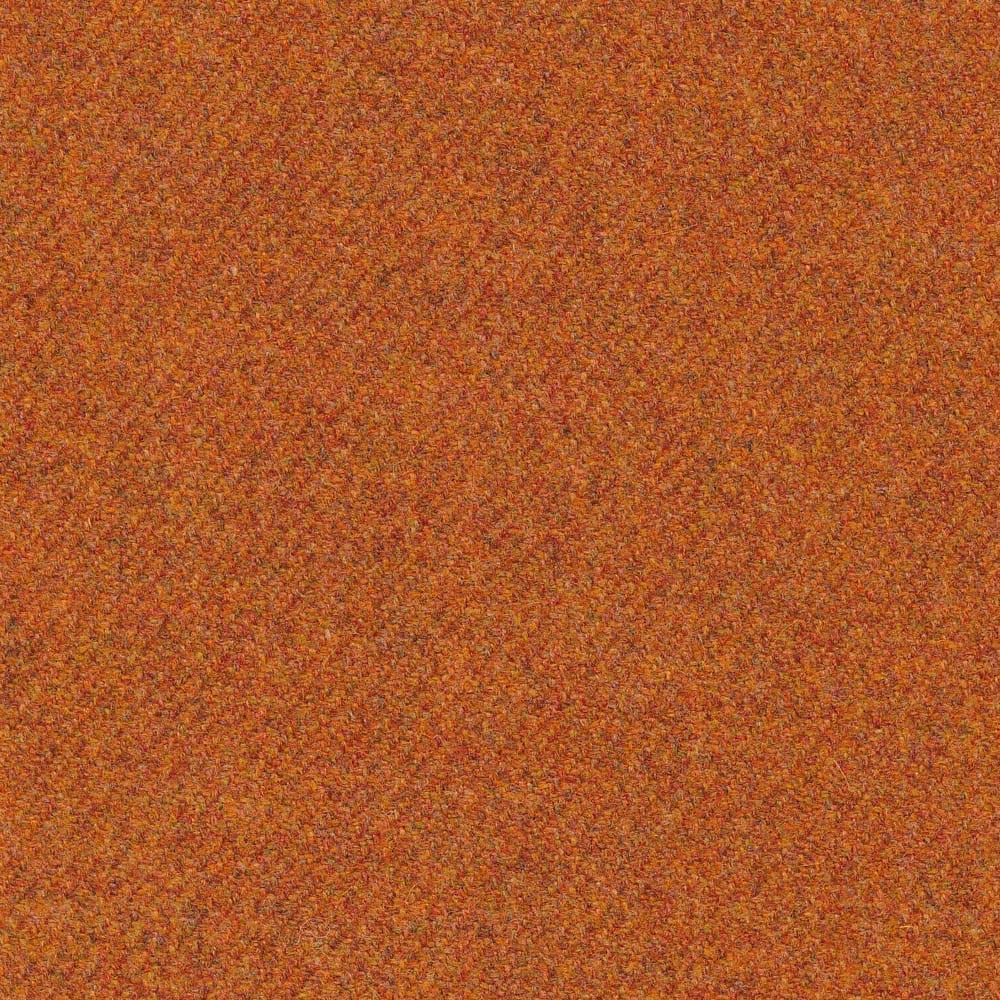 Close-up of warm ginger-orange woven texture with rust, ochre and brown flecks
