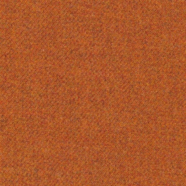 Close-up of warm ginger-orange woven texture with rust, ochre and brown flecks