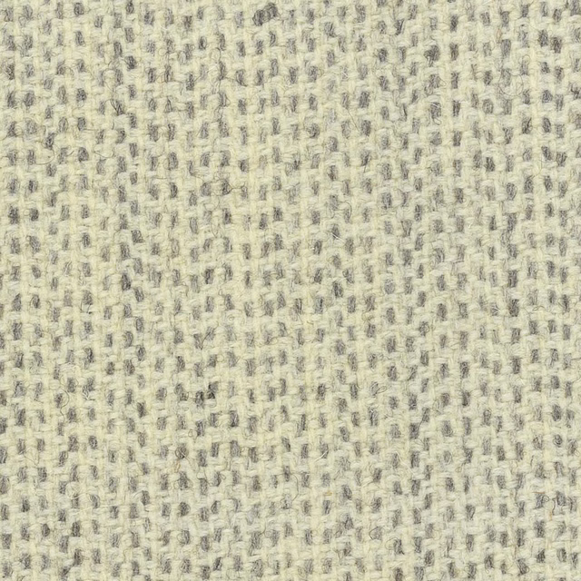 Pale cream nubby woven fabric with scattered soft grey flecks and tactile texture