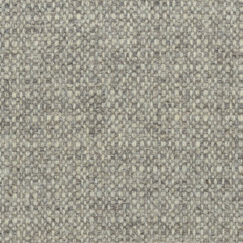 Close-up of warm greige woven texture with mottled fibres and small raised loops