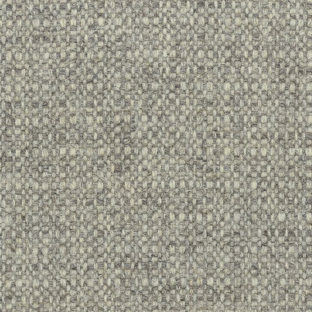 Close-up of warm greige woven texture with mottled fibres and small raised loops