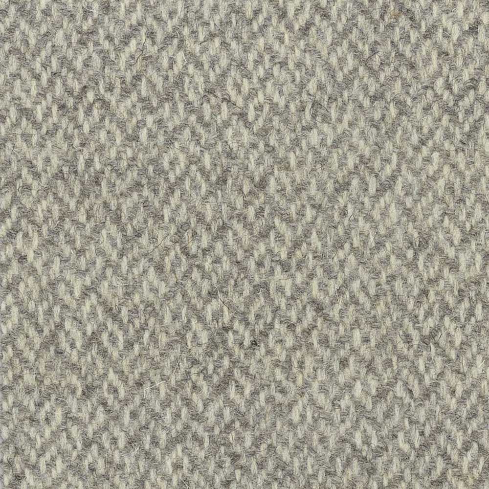 Pale stone-grey woven textile with broken herringbone texture and ivory flecks