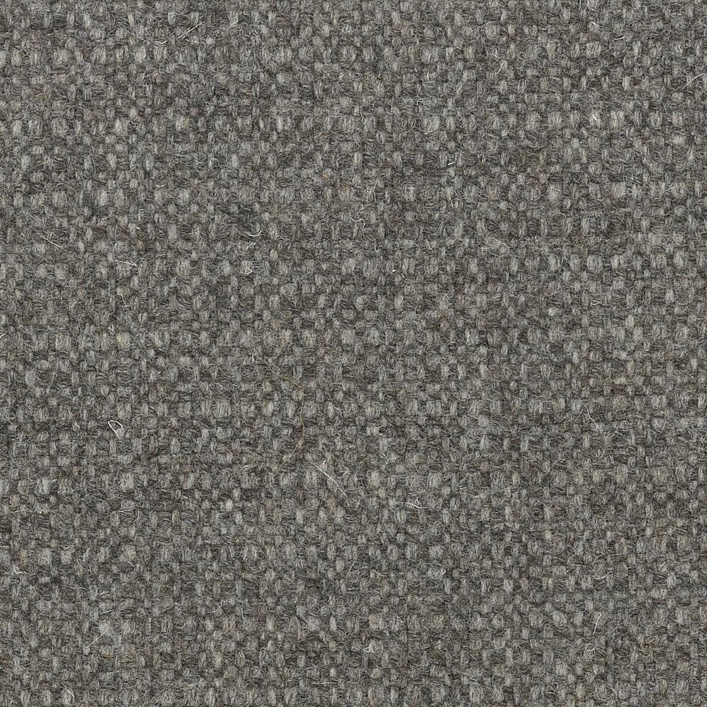 Mottled charcoal-grey undyed wool with a dense, irregular woven texture