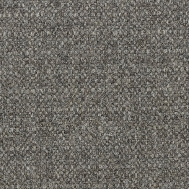 Mottled charcoal-grey undyed wool with a dense, irregular woven texture