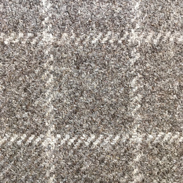 Close-up of taupe-grey undyed-looking weave with cream flecks and diagonal texture