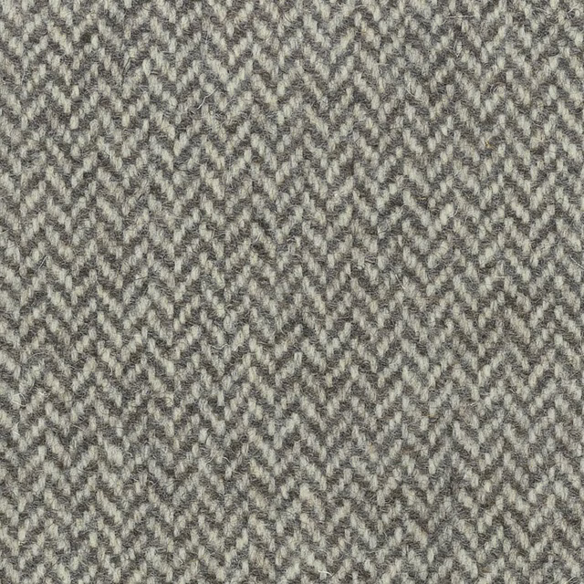 Muted grey-beige textile with small broken chevron weave and charcoal flecks