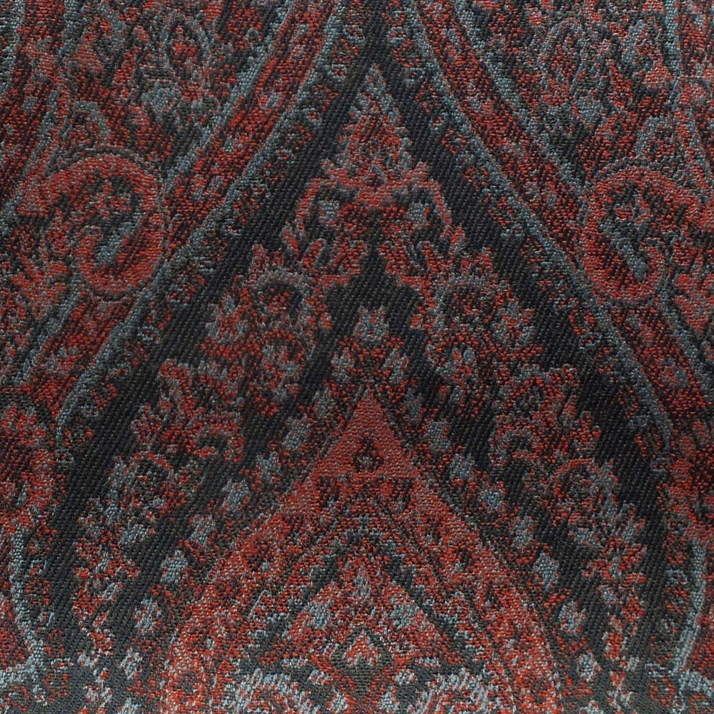 Dense damask weave in pimento red, charcoal, and blue-grey with ornate symmetrical motifs