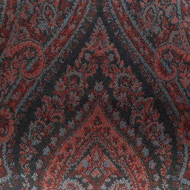 Dense damask weave in pimento red, charcoal, and blue-grey with ornate symmetrical motifs