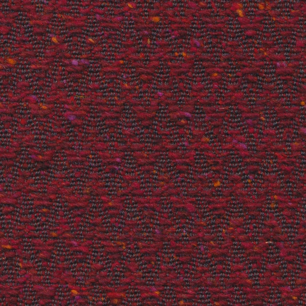 Deep garnet woven upholstery with broken charcoal chevrons and rust flecks