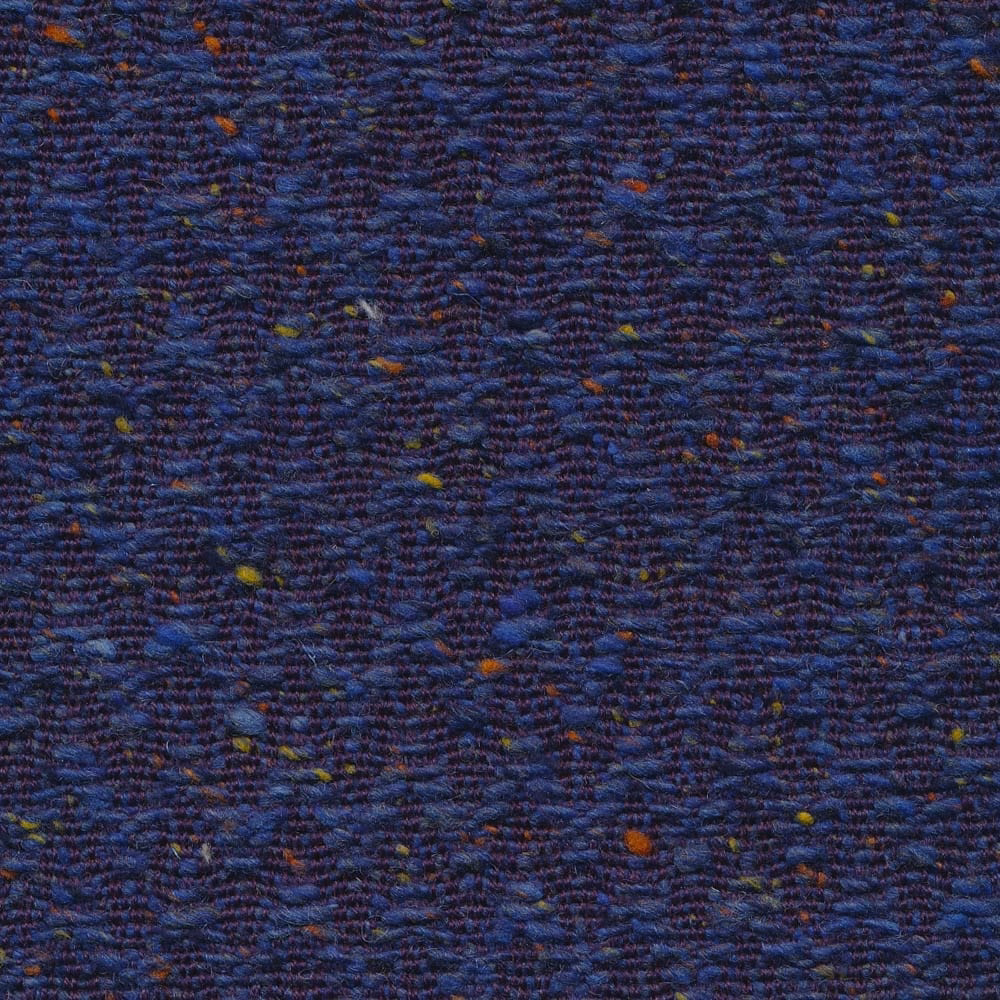 Close-up of deep royal-blue chevron weave with rust and ochre flecks