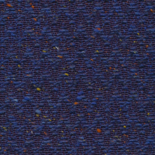 Close-up of deep royal-blue chevron weave with rust and ochre flecks