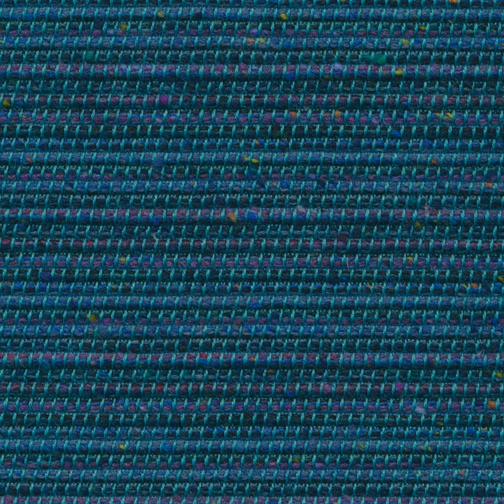 Close-up of dense deep teal weave with purple and blue flecks