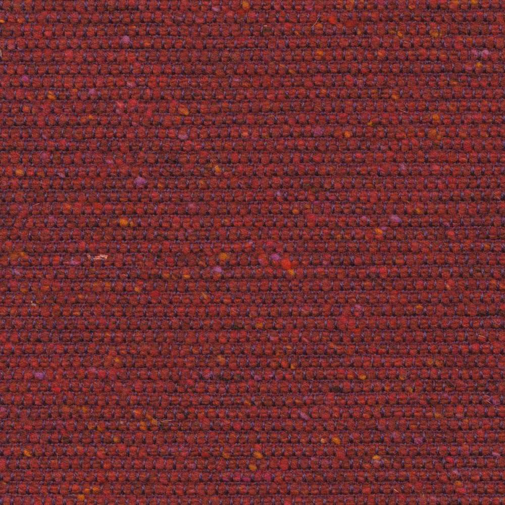 Close-up of dense rosehip-red weave with plum shadows and rust flecks