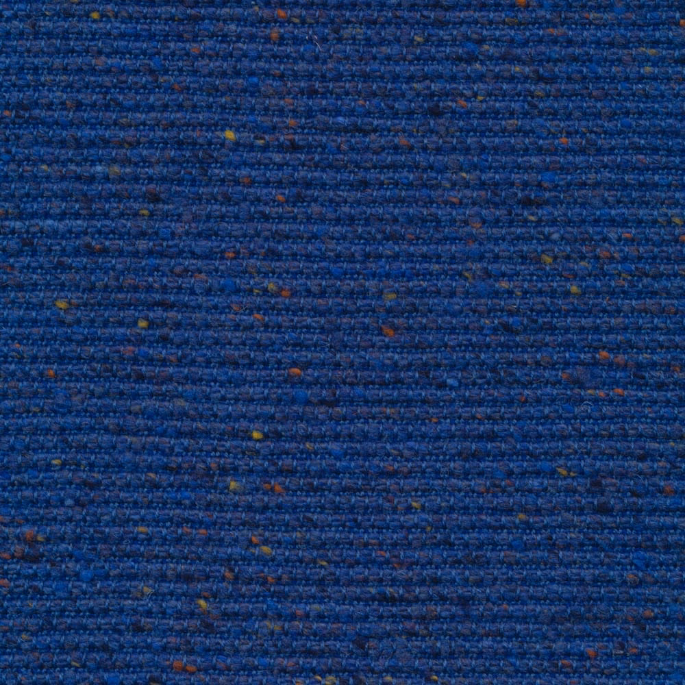 Deep royal-blue nubby weave with horizontal texture and scattered ochre and rust flecks