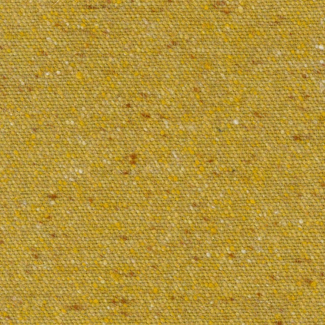 Close-up of mustard-gold woven fabric with cream, ochre and brown flecks