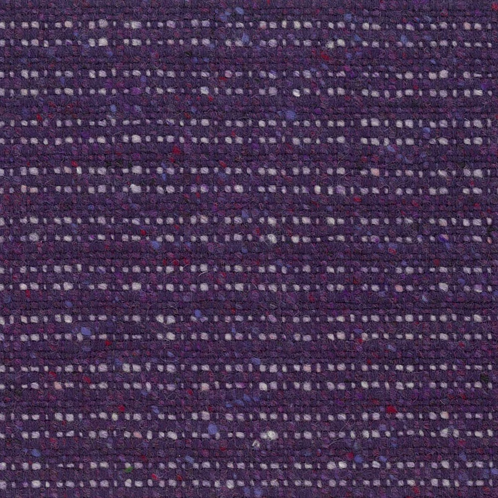 Close-up of dark purple woven textile with lilac, cream, blue and red flecks