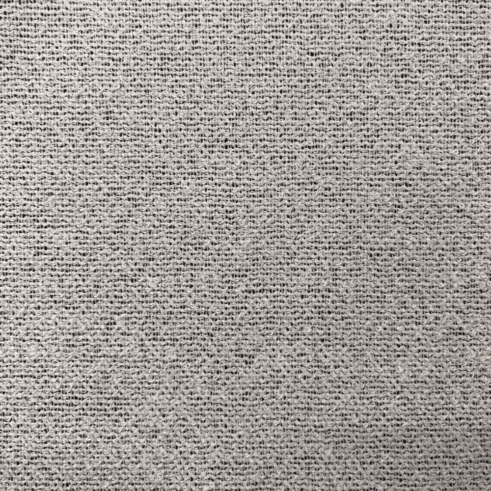 Close-up of soft white open weave with delicate grey flecks and textured threads