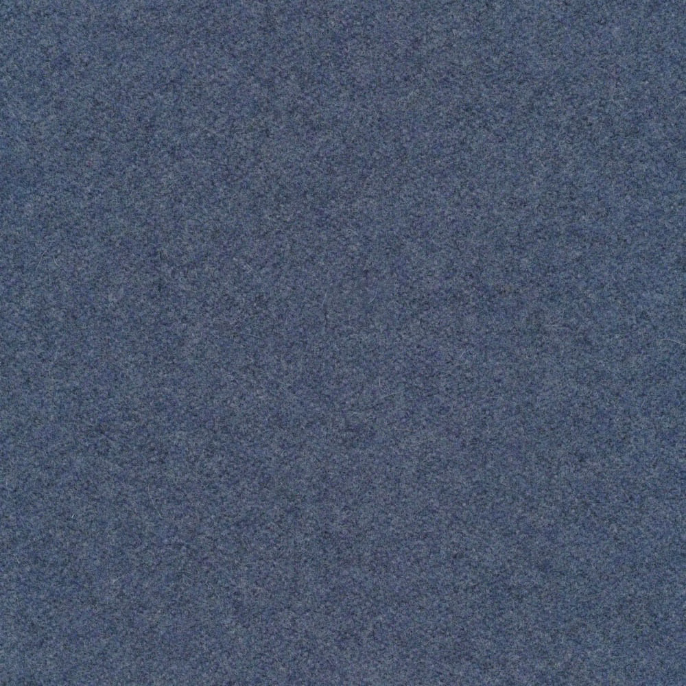 Close-up of muted slate-blue melton fabric with fine grey mottling and soft texture