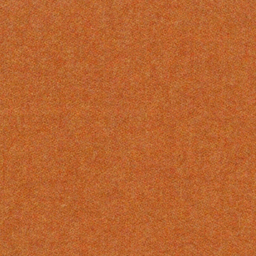 Close view of mottled ochre-gold melton weave with warm rust-orange flecks