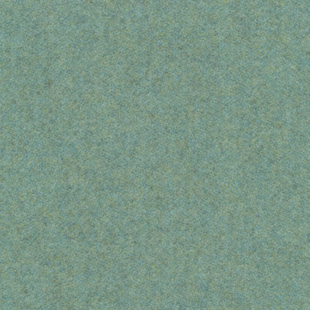 Close-up of muted mint green fabric with softly mottled blue-grey woven texture
