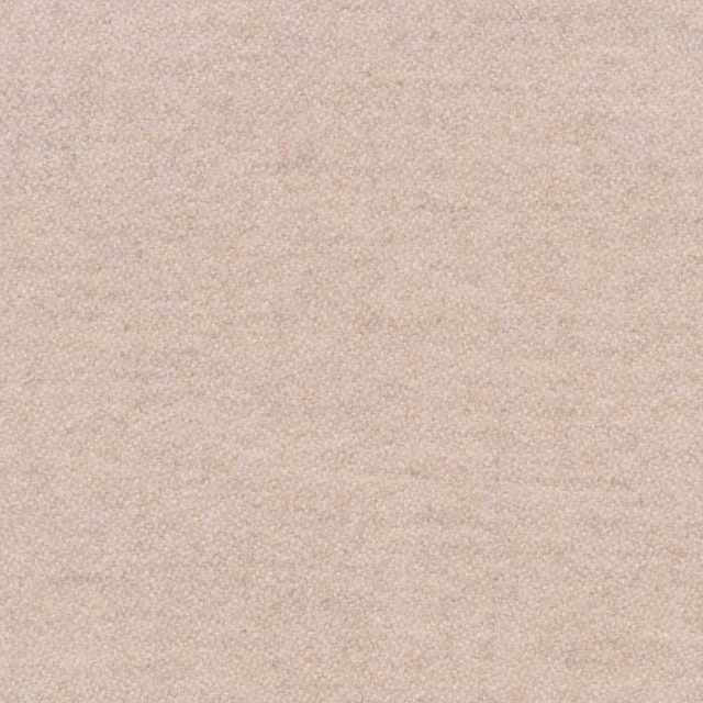 Close-up of warm oat-beige fabric with a fine, softly pebbled weave