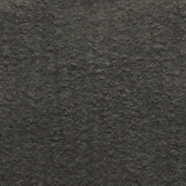 Dark charcoal-black bouclé with dense nubby loops and softly mottled texture