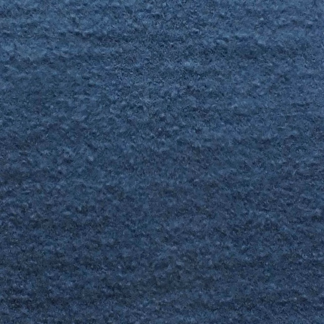 Deep smoky blue bouclé fabric with irregular nubby texture and darker mottled flecks